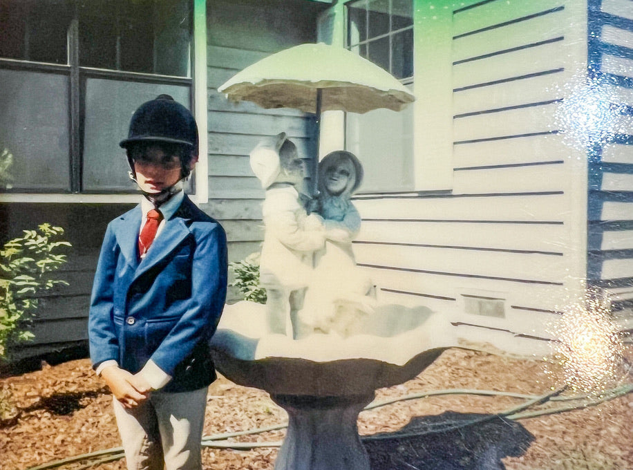Elli stands in her equestrian clothes