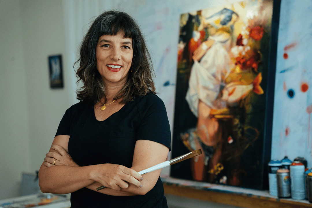 Artist Elli Milan in her art studio, paint brush, spray paint