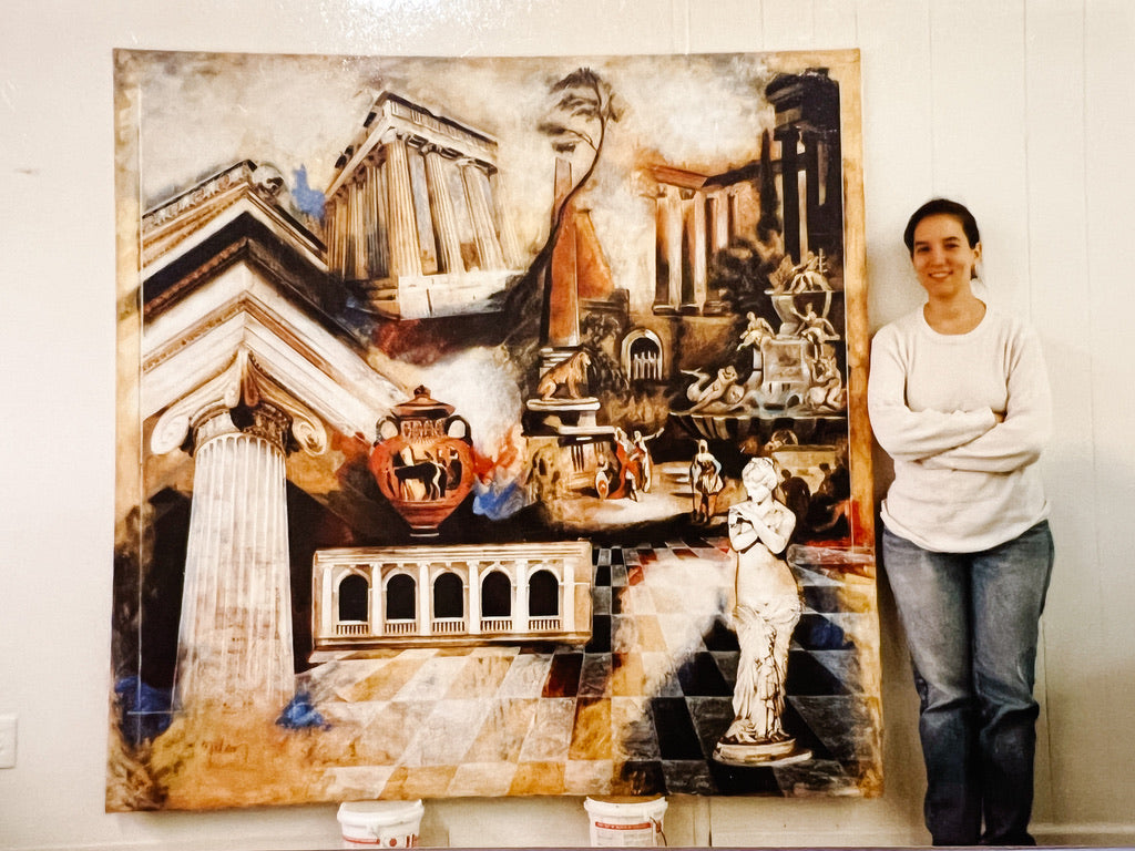 Young Elli stands next to a large painting of Greek imagery