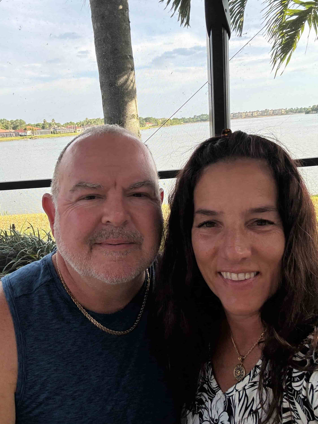 John and Elli Milan smile inside a beautiful Florida home.