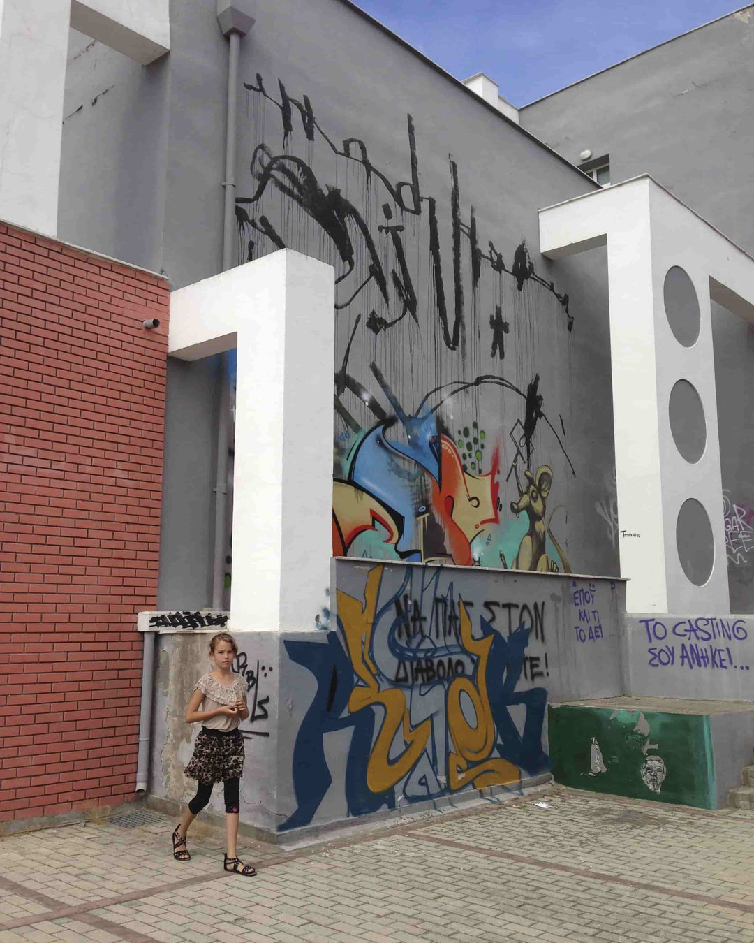 A side view of a building in Greece filled with graffiti