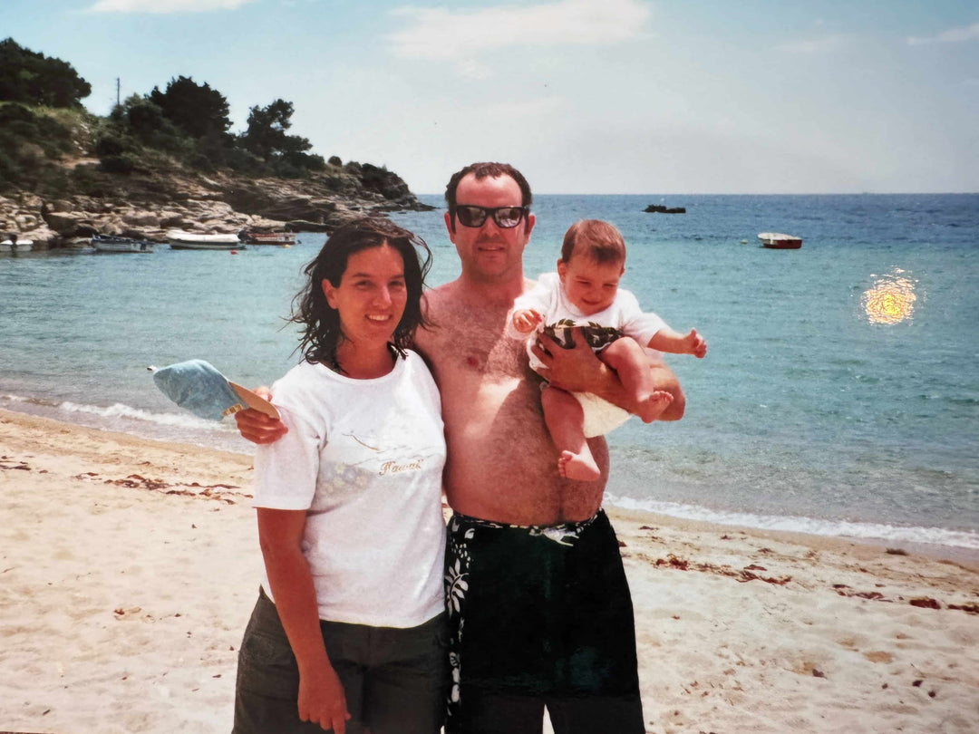 Elli, John, and baby Dimitra on a beach in Greece
