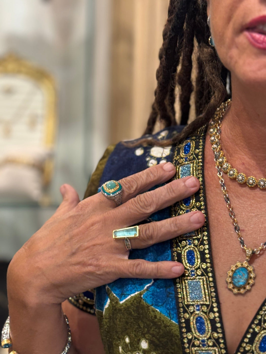 Elli Milan wearing rings, necklaces, and earrings from her jewelry collection